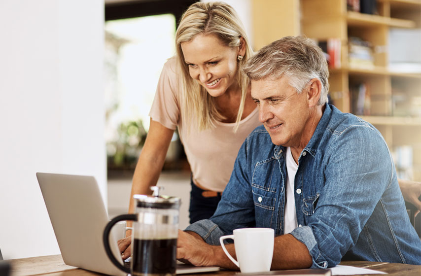 Two seniors using a laptop in their kitchen - computer repair for seniors near Prescott AZ