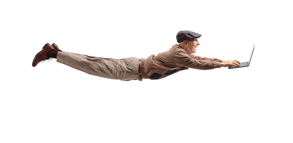 Senior man flying with an open laptop - computer repair Prescott Valley AZ